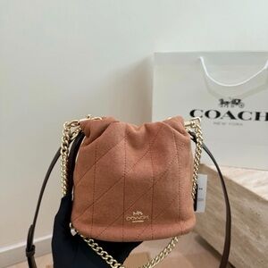 COACH Quilted Drawstring Crossbody Bag in Rust